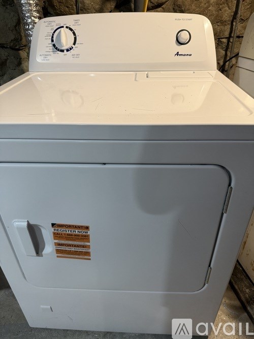 A white washing machine with a sticker on the door.