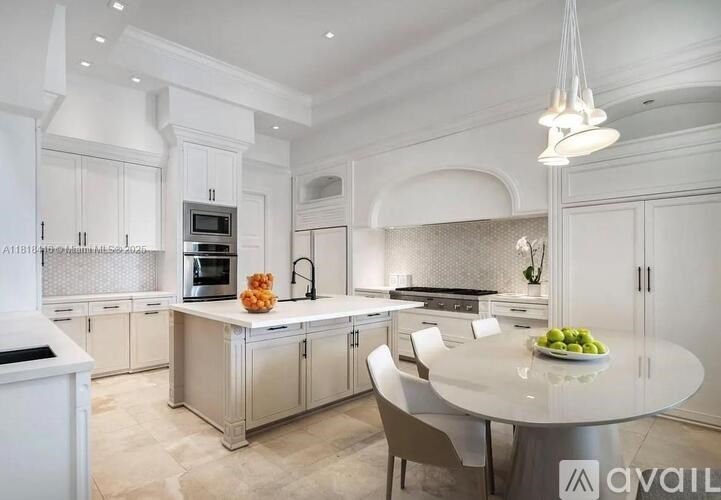 A modern kitchen with a dining table set for two.