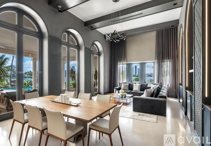 A modern dining room with a large table and chairs.