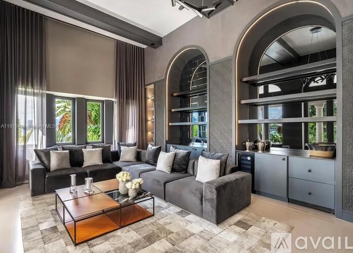 A modern living room with a grey sofa set and a wooden coffee table.