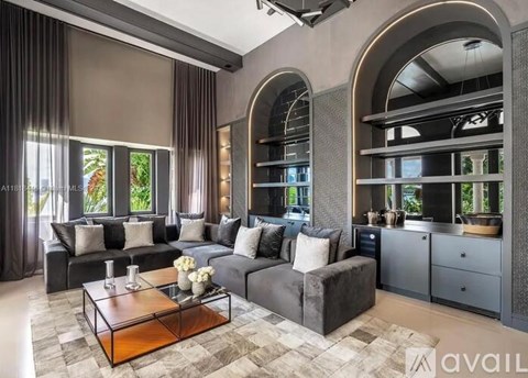 A modern living room with a grey sofa set and a wooden coffee table.