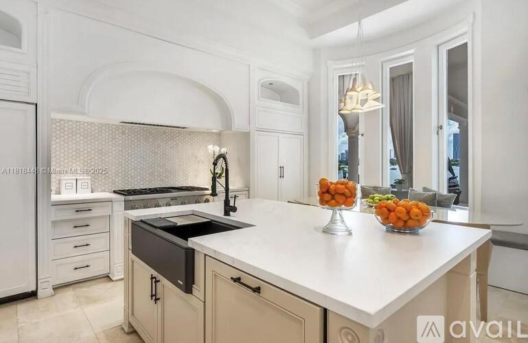 A kitchen with a white countertop and a black stove top.