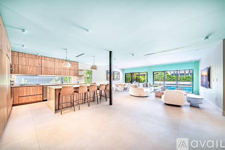 A modern kitchen with a bar area and a dining table set up.
