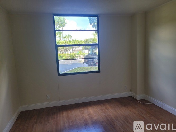 A room with a large window overlooking a street.