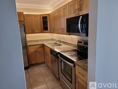 A kitchen with wooden cabinets and stainless steel appliances.