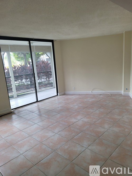 A room with tiled flooring and sliding glass doors.