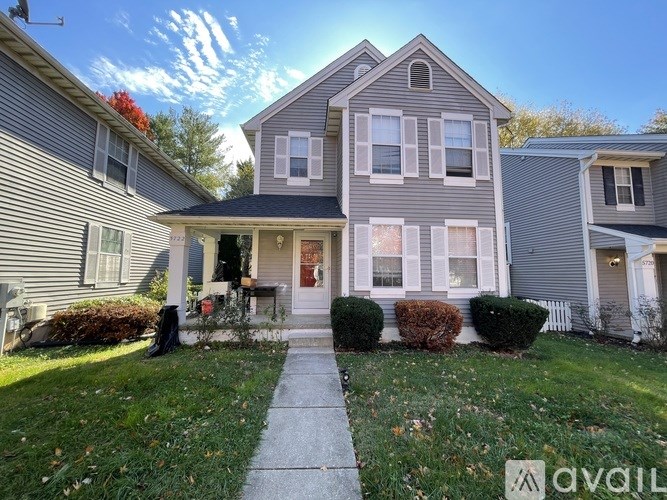 A house with a front yard and a walkway leading to the front door.