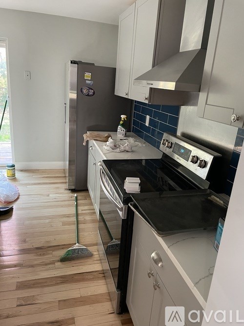 A kitchen with a white fridge and a white stove top oven.