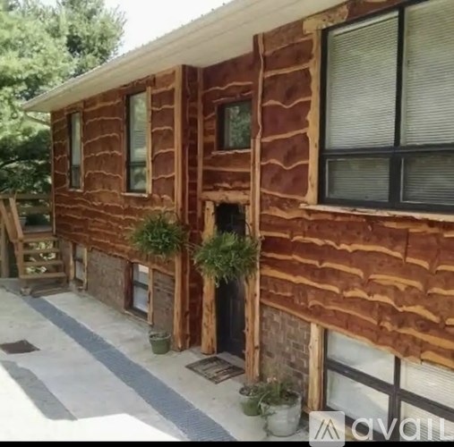 A wooden house with a porch and a door.