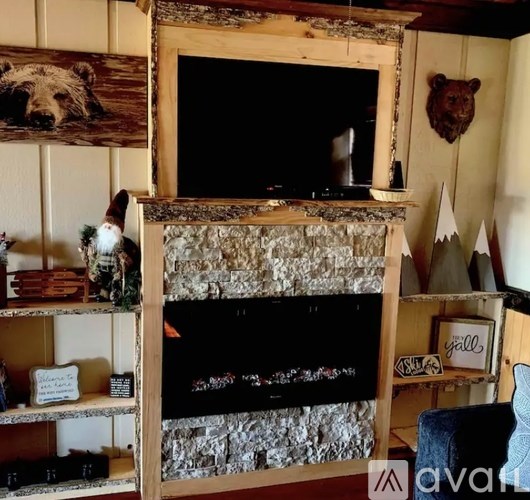 A fireplace with a bear head mounted above it.