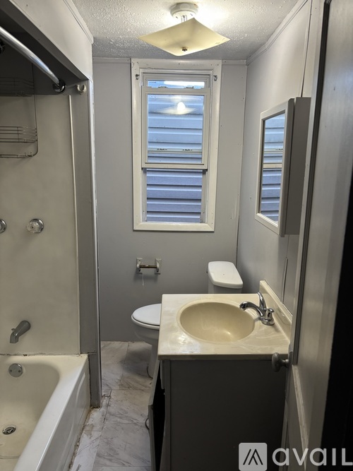 A bathroom with a sink, toilet, and bathtub.