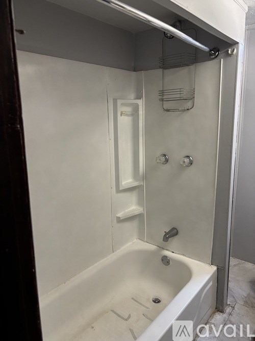 A white bathroom with a tub and a shower.