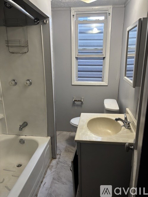 A bathroom with a sink, toilet, and bathtub.