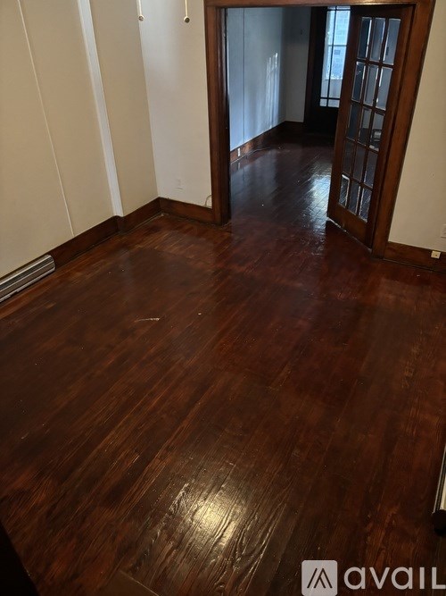 A room with a wooden floor and a door.