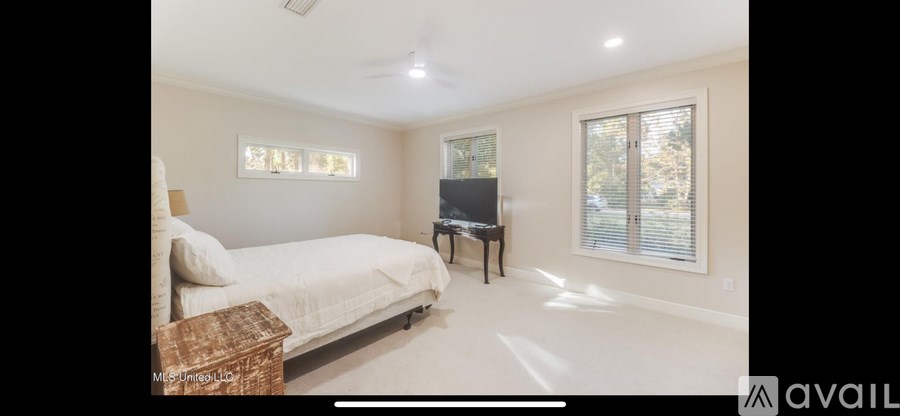 A bedroom with a bed, a piano, and a window.