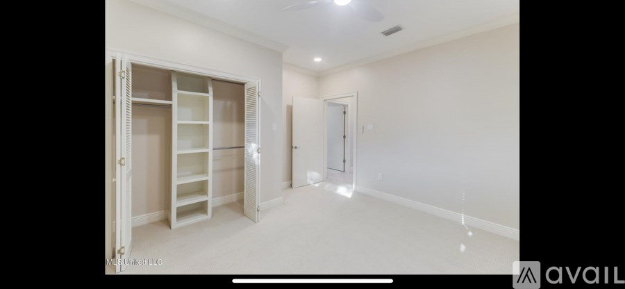 A large, empty room with a built-in closet.