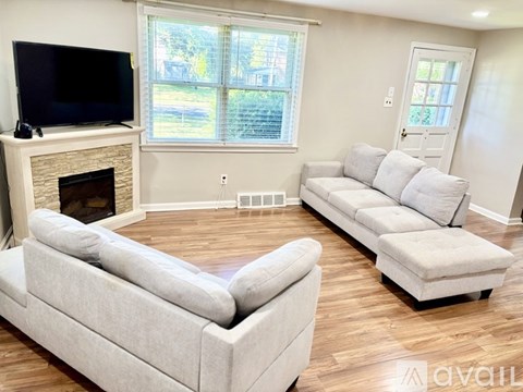 A living room with a fireplace and a television on top of it.
