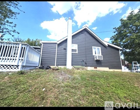 A house with a grey exterior and a white fence.