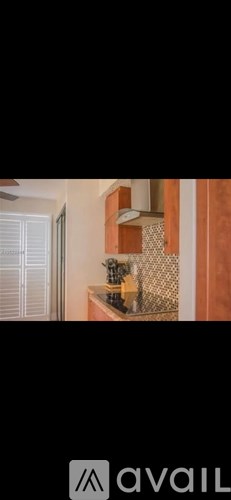 A kitchen with wooden cabinets and a tiled backsplash.