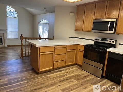 A kitchen with wooden cabinets and a white countertop.