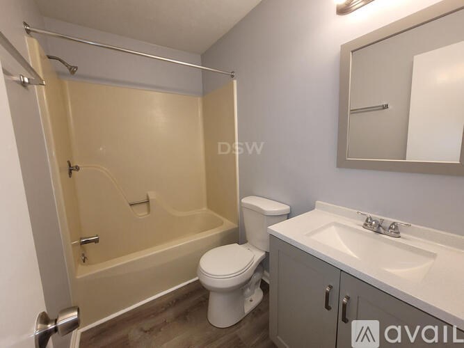 A bathroom with a toilet, sink, and bathtub.
