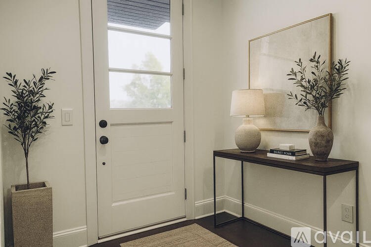 A white door with a black handle is flanked by two vases.