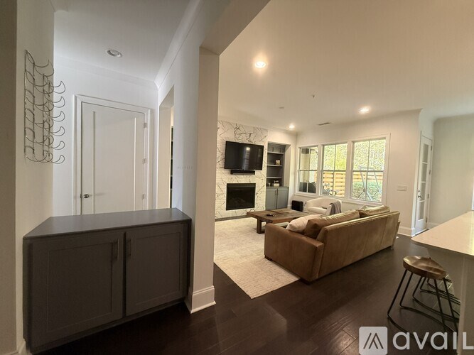 A living room with a brown couch and a television.