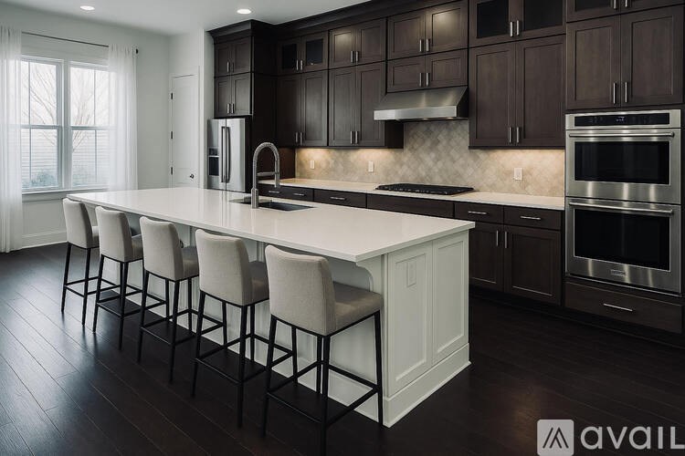 A modern kitchen with dark brown cabinets and white countertops.
