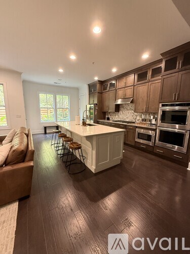 A kitchen with brown floors and a white island.