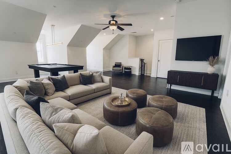 A living room with a large sectional sofa and a coffee table.