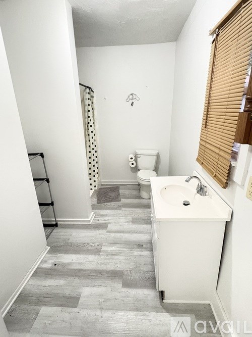A white sink in a bathroom with a grey floor.