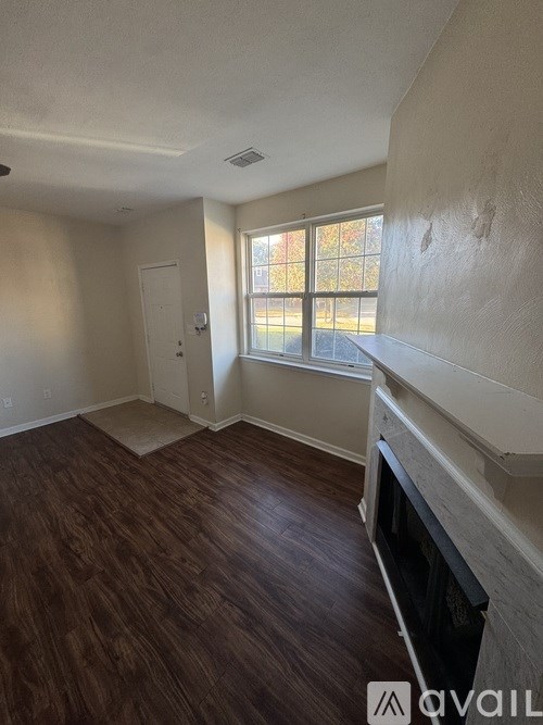 A room with a fireplace and a window.