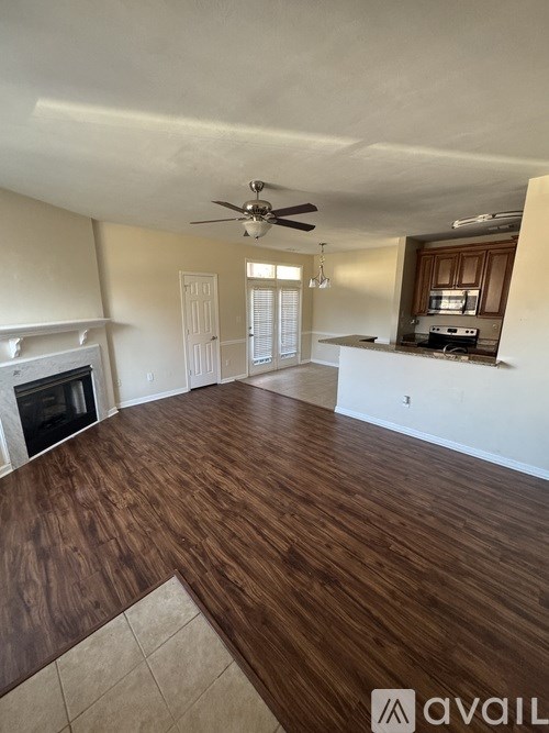 A living room with a fireplace and wood flooring.