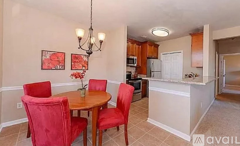 A dining room with a table and chairs.
