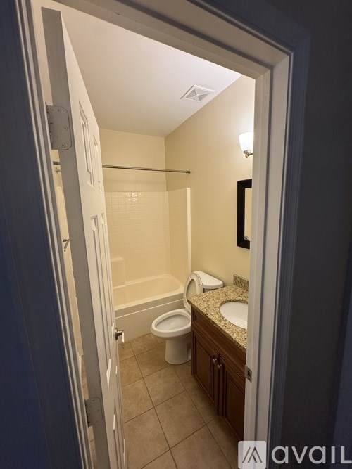 A bathroom with a toilet, sink, and shower.