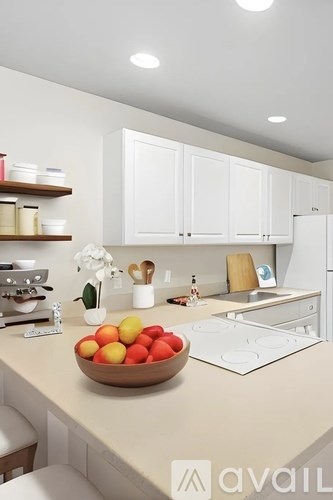 A kitchen with a bowl of fruit on the counter.