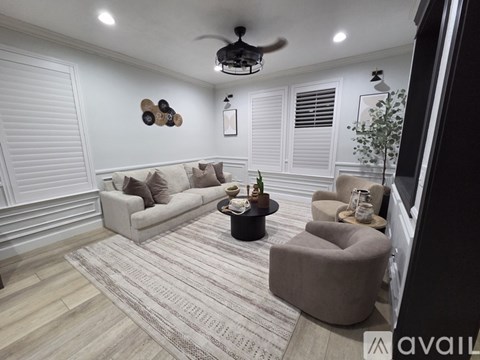 A living room with a couch, chair, and a rug.