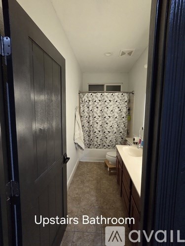 A bathroom with a toilet, sink, and shower.