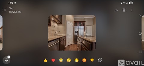 A kitchen with a refrigerator, sink, and cabinets.