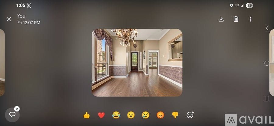 A room with a chandelier and a doorway leading to another room.