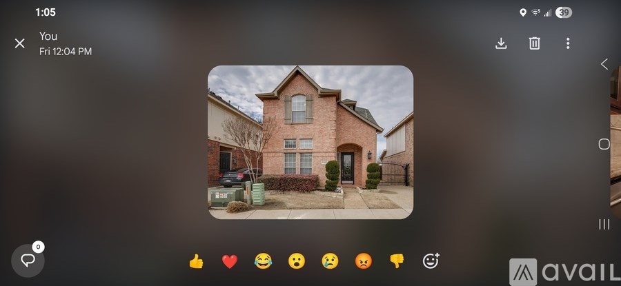 A brick house with a dark sky in the background.