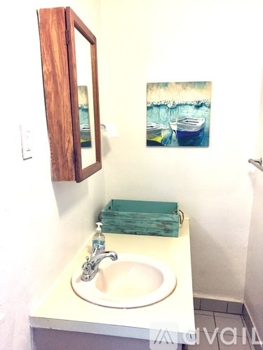 A bathroom with a sink and a mirror.