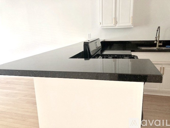 A black countertop with a toaster oven on it.