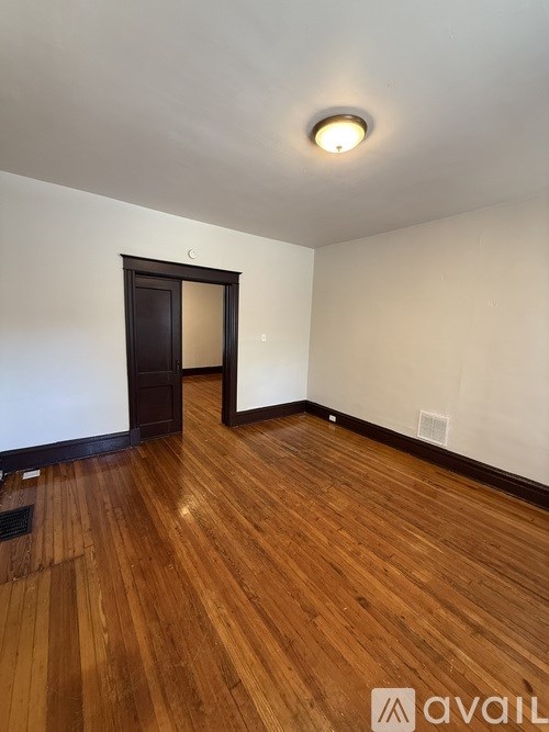 A room with wooden floors and a door.