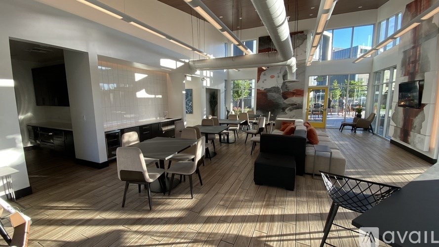 A modern open plan office space with wooden floors and furniture.