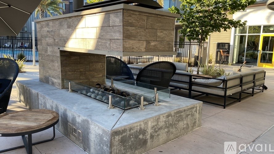 A patio with a fireplace and seating area.
