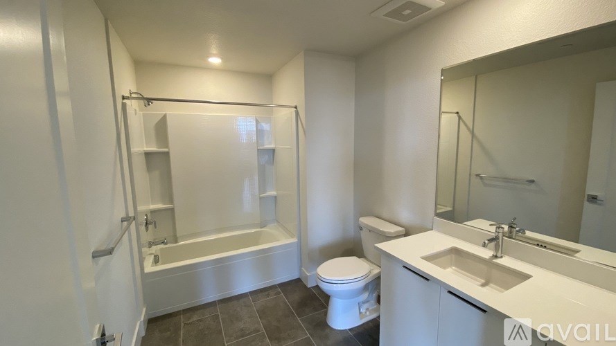 A white bathroom with a toilet, sink, and bathtub.