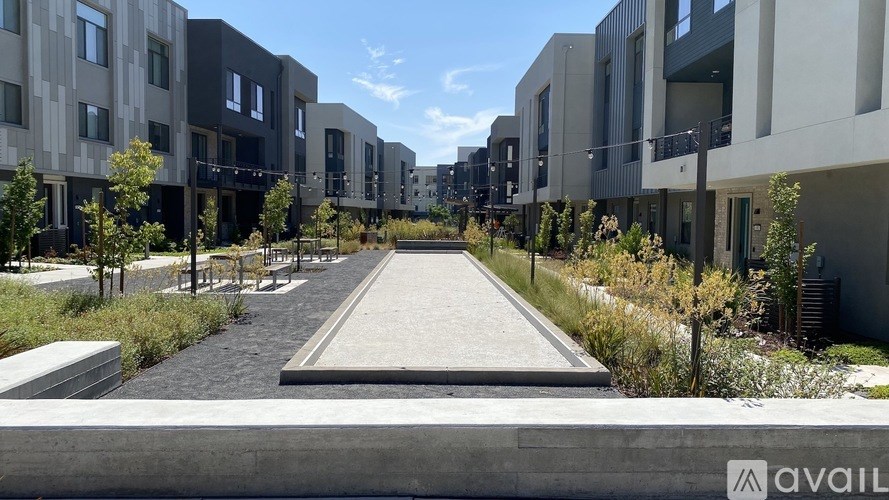 A modern residential area with a long walkway in the middle.