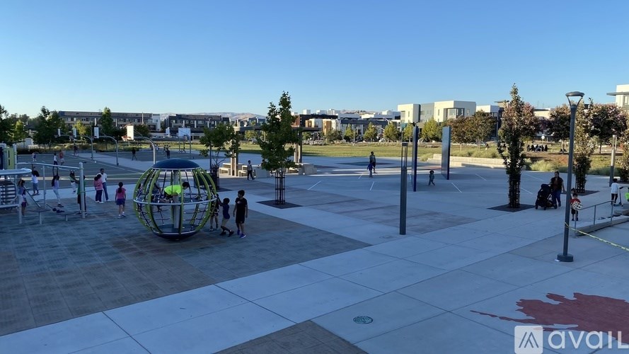 A large open plaza with people walking and sitting.