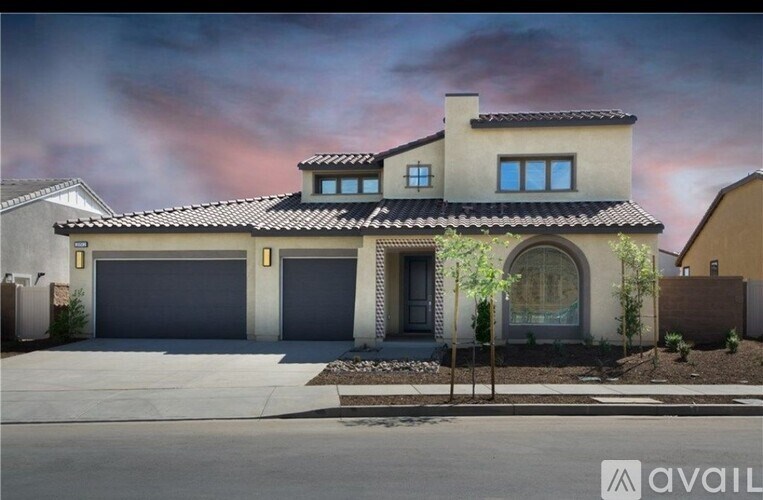 A house with a garage and a driveway in front.